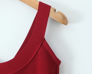 Close-up of wine red ribbed knit fabric on a strap dress with detailed stitching