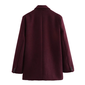 Detail of the straight back seam and black sleeve buttons on a dark wine red wool coat