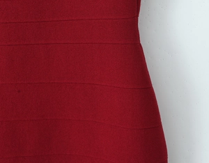 Detailed macro shot of burgundy bandage knit fabric with horizontal ribbed texture