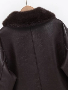 Detail of premium brown faux fur collar and textured leather back on a winter coat