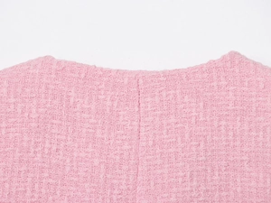 Close-up of pink tweed jacket neckline showing exquisite woven texture and craftsmanship