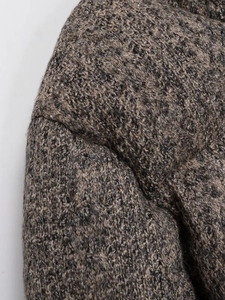 Detailed close-up showing the heavy multi-color knit texture and thick tweed fabric of the jacket