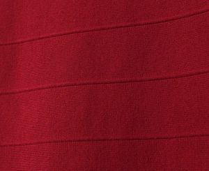 Macro view of dark red bandage dress fabric with elastic horizontal ribbed texture