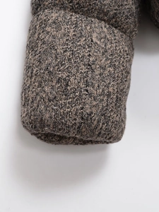 Close-up of thick knit mixed-color winter jacket sleeve with textured tweed fabric finish