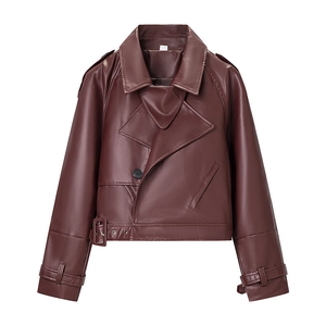 Detail of burgundy faux leather moto jacket showing wide lapels and belt buckle textures
