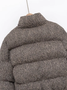 Macro detail of brown-grey winter jacket with knitted texture and high stand collar