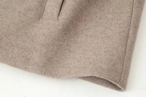 Detail of premium wool blend fabric with high-quality stitching and hidden side pocket