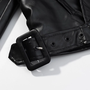 Detailed close-up of a black leather biker jacket waist belt with silver metal buckle