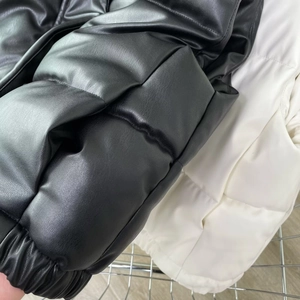 Close-up of quilted PU leather texture and elastic cuffs on hooded puffer vests