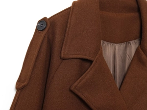 Detail of wool-blend coat collar featuring shoulder epaulet and black resin button