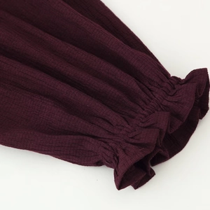 Deep burgundy long sleeve blouse with elegant pleated elastic cuffs and ribbed texture