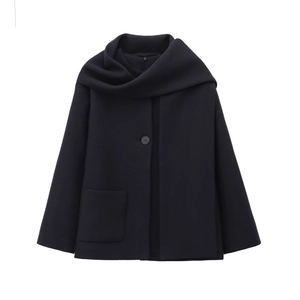 Detail of black wool-like coat featuring a unique scarf collar and large rectangular pocket