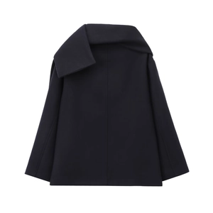 Close-up of navy wool coat featuring an asymmetric oversized lapel and sculptural silhouette