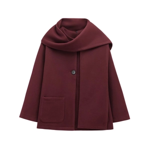 Detail of burgundy wool coat showing the scarf collar design and black button closure