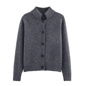 Detail of dark grey knit cardigan featuring stand collar and textured golden thread finish