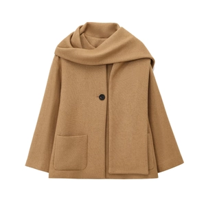 Detail of camel wool coat featuring integrated scarf design and black button closure