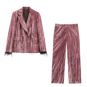 Detail view of velvet blazer with feather-trimmed cuffs and matching wide-leg trousers