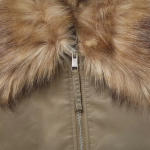 Detail of faux fur collar and premium metal zipper on khaki aviator bomber jacket