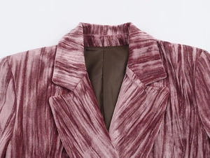Macro detail of pink velvet blazer showing pleated texture and premium notched lapel finish