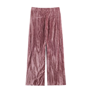 Detailed macro view of crushed velvet high-waisted wide-leg trousers in magenta pink