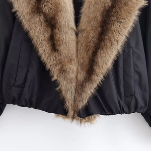 Women's black puffer jacket with thick brown faux fur collar and elastic hem