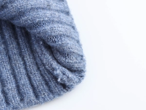 Close-up of light blue rib-knitted hoodie showing soft texture and fine fabric details