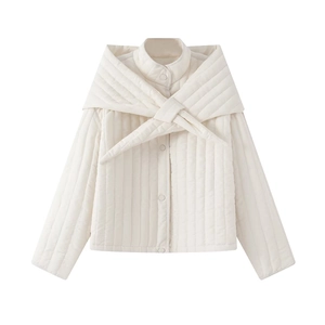 Detail view of cream quilted jacket featuring stand collar and unique knotted scarf lapels