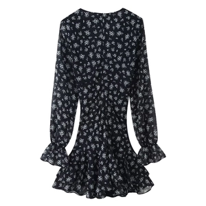 Back view of a long sleeve floral mini dress featuring ruffled hem and back zipper detail