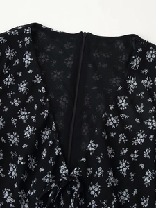 Detail of V-neck back with invisible zipper and lace-up on black floral chiffon dress