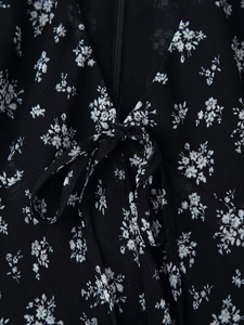 Detail of floral print fabric with bow tie design and hidden zipper for women's dress