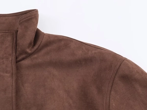 Close-up of brown faux suede jacket detail showing stand collar and fine stitching
