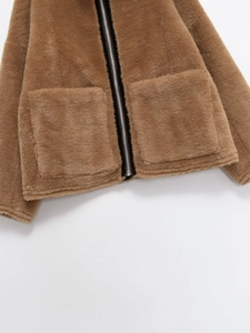 Détail de la veste en fausse fourrure marron avec zip argenté et grandes poches