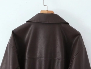 Detail view of the back shoulder seams and collar on this dark brown PU leather jacket