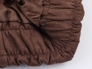 Detail view of the brown corduroy fabric texture and smooth satin lining on the jacket