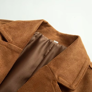 Detail of caramel suede blazer collar with precision stitching and soft inner lining