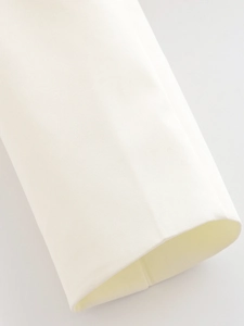 Gros plan de la manche de veste blanche avec texture fine et détails de couture d'ourlet