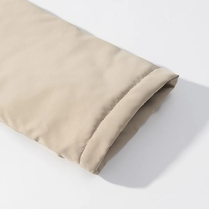 Close-up of khaki hooded jacket cuff showing high-quality double-stitched sewing details