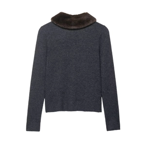 Detail view of the back of a dark grey knit cardigan with a brown faux fur collar