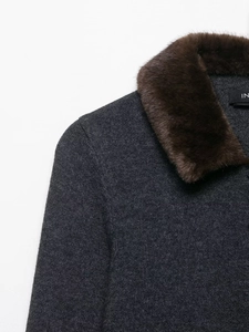 Detailed view of grey knit cardigan featuring a soft brown faux fur collar and inner label