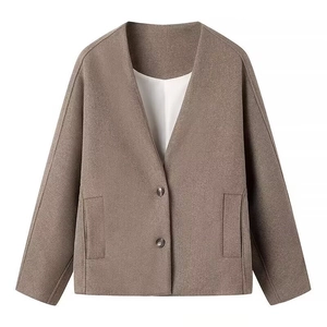 Detail view of a brown wool jacket with V-neckline, two buttons, and front pockets