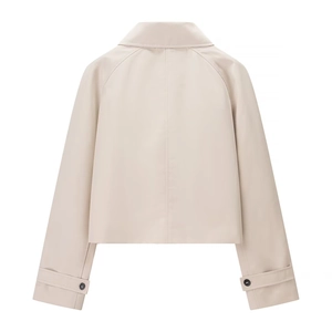 Back view of a minimalist short trench jacket in beige with raglan sleeves and lapel