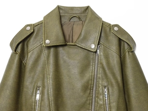 Detailed macro shot of olive green faux leather jacket with silver metal snap buttons