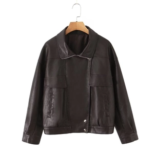 Detail of dark brown faux leather jacket with turn-down collar and silver buckle accents