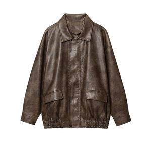Macro detail of vintage brown PU leather texture on oversized jacket with large pockets