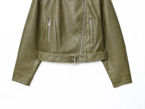 Detail of olive green washed leather jacket featuring belted waist and metal zippers