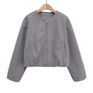 Close-up of a grey wool-like jacket featuring a round neck and metallic zipper detail