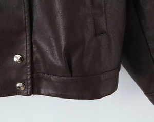 Detailed view of dark brown PU leather jacket with silver buttons and stitching
