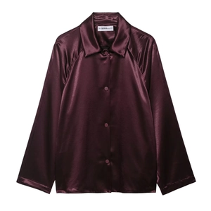 Detailed view of the smooth burgundy satin jacket collar and branded interior label