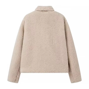 Macro detail of beige faux fur jacket back view with fluffy texture and stand-up collar