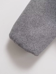 Close-up of grey tweed fabric texture and thick wool blend material for baseball jacket